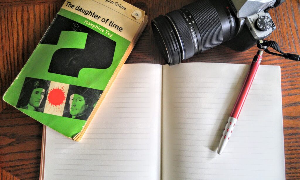 camera, book, and notebook